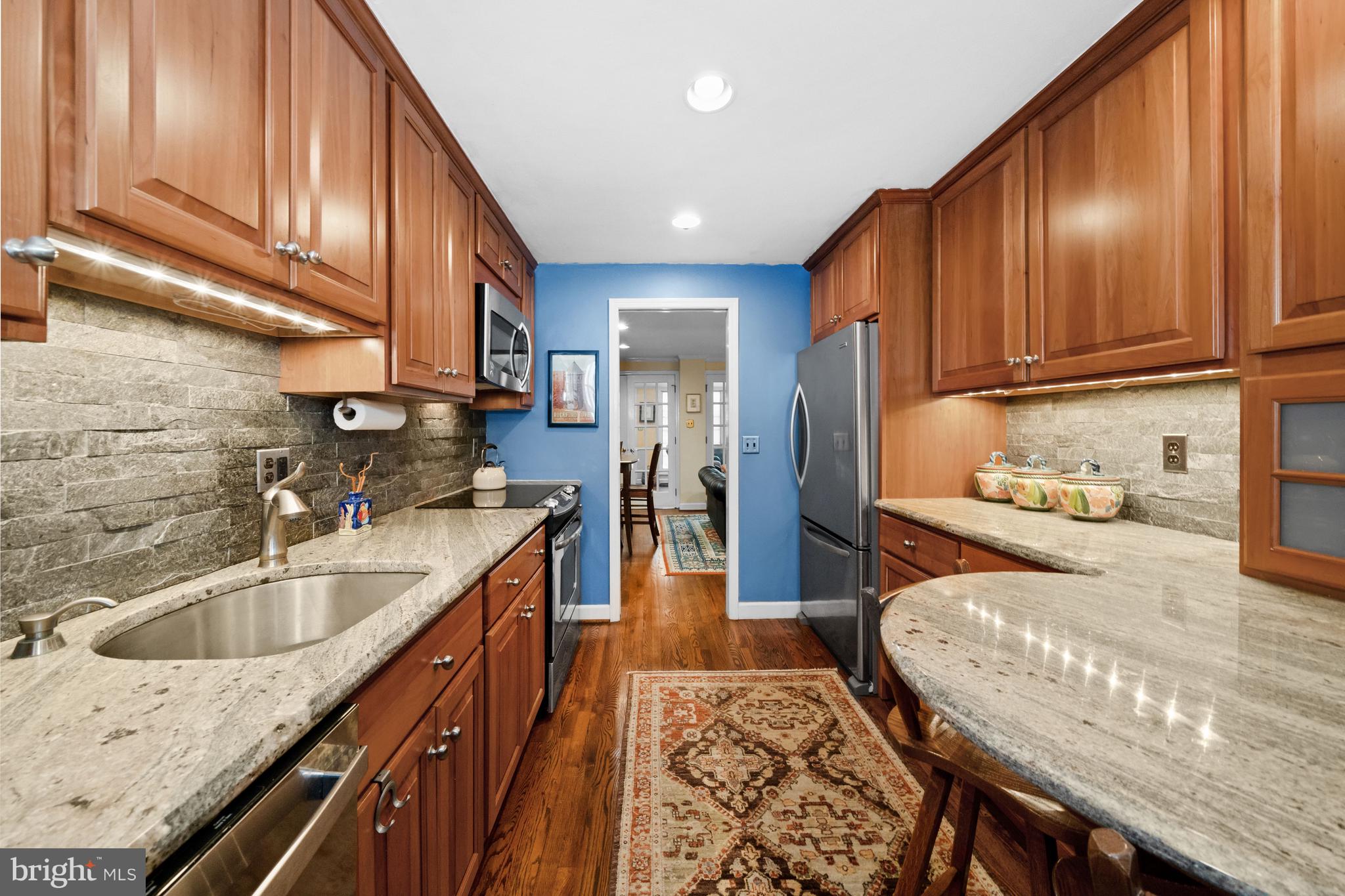 55 Ivy Road Wilmington, DE 19806 - Photo 13 of 38 a kitchen with stainless steel appliances granite countertop wooden cabinets a sink and dishwasher