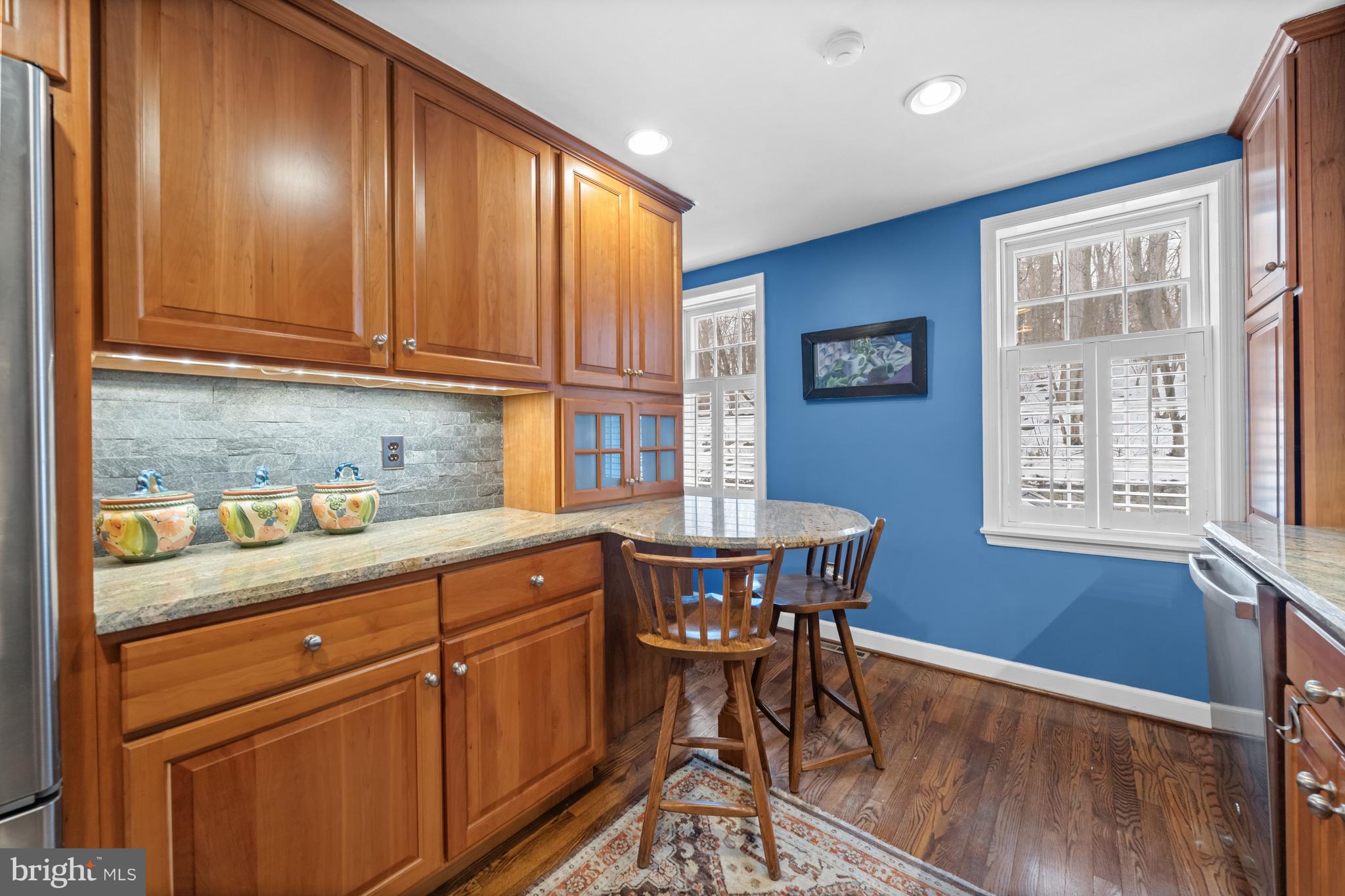 55 Ivy Road Wilmington, DE 19806 - Photo 14 of 38 a kitchen with stainless steel appliances granite countertop wooden cabinets a dining table and chairs