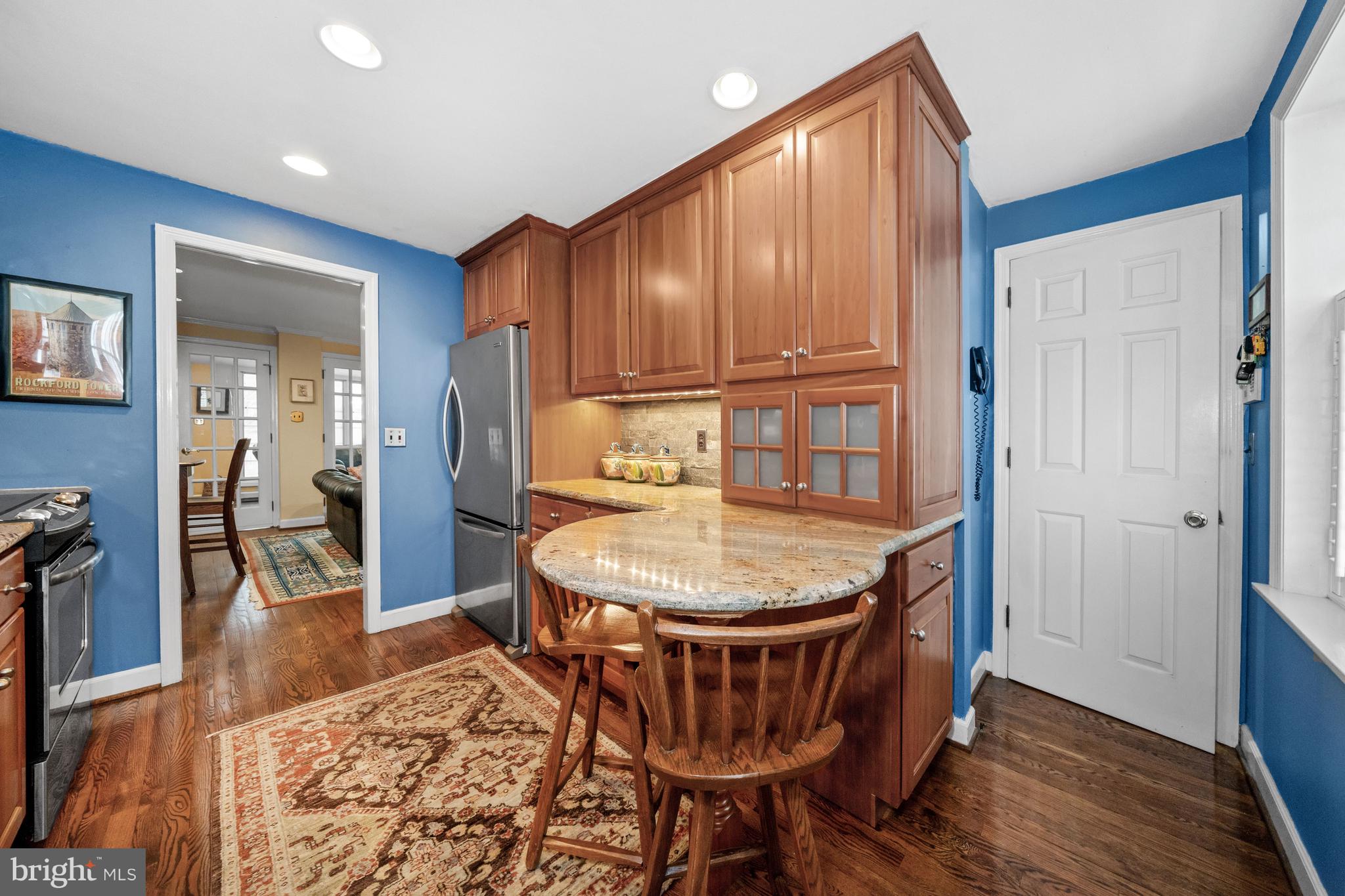 55 Ivy Road Wilmington, DE 19806 - Photo 15 of 38 a dining room with furniture wooden floor a rug and a painting