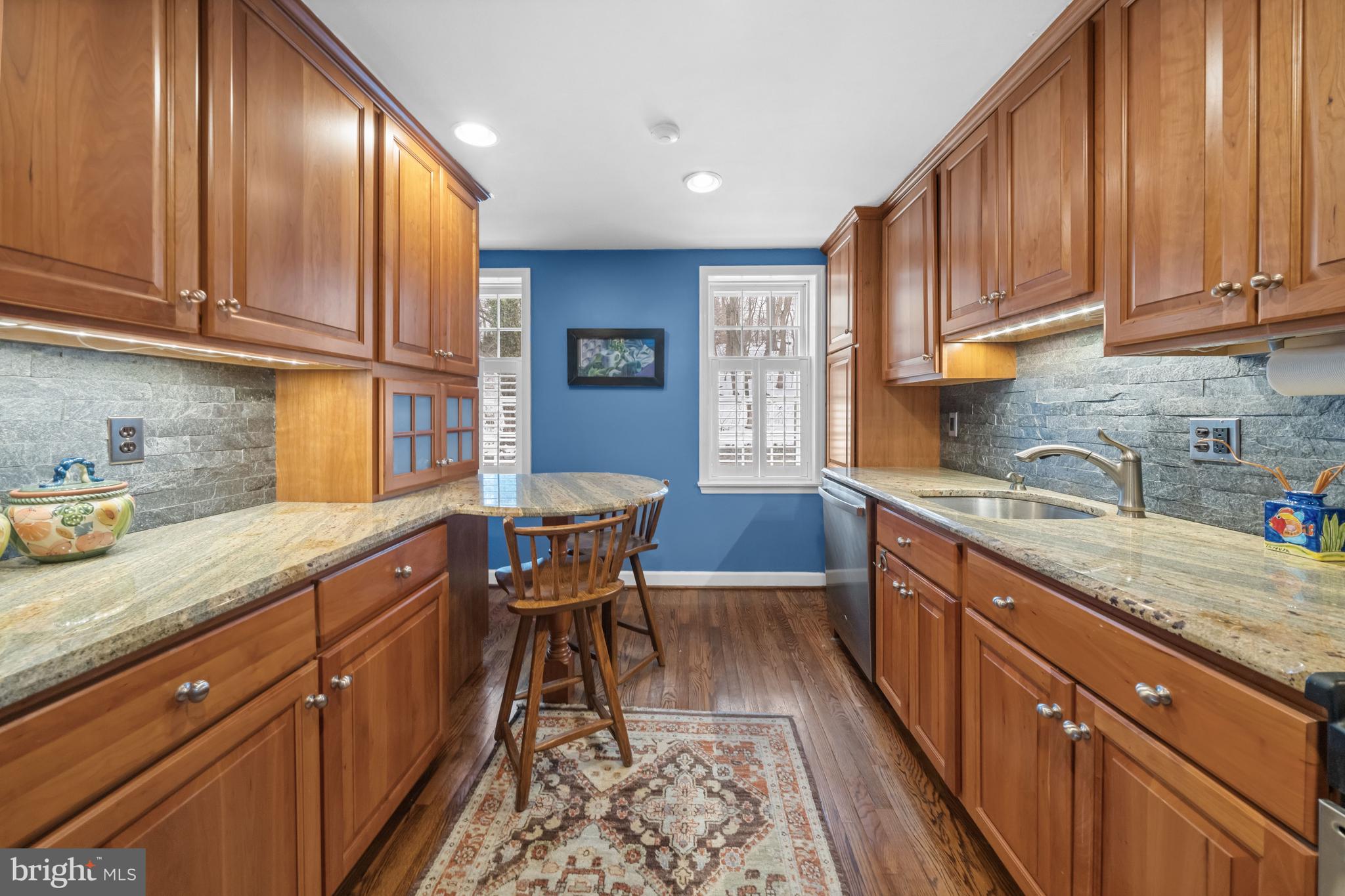 55 Ivy Road Wilmington, DE 19806 - Photo 17 of 38 a kitchen with granite countertop wooden cabinets stainless steel appliances a sink and a window
