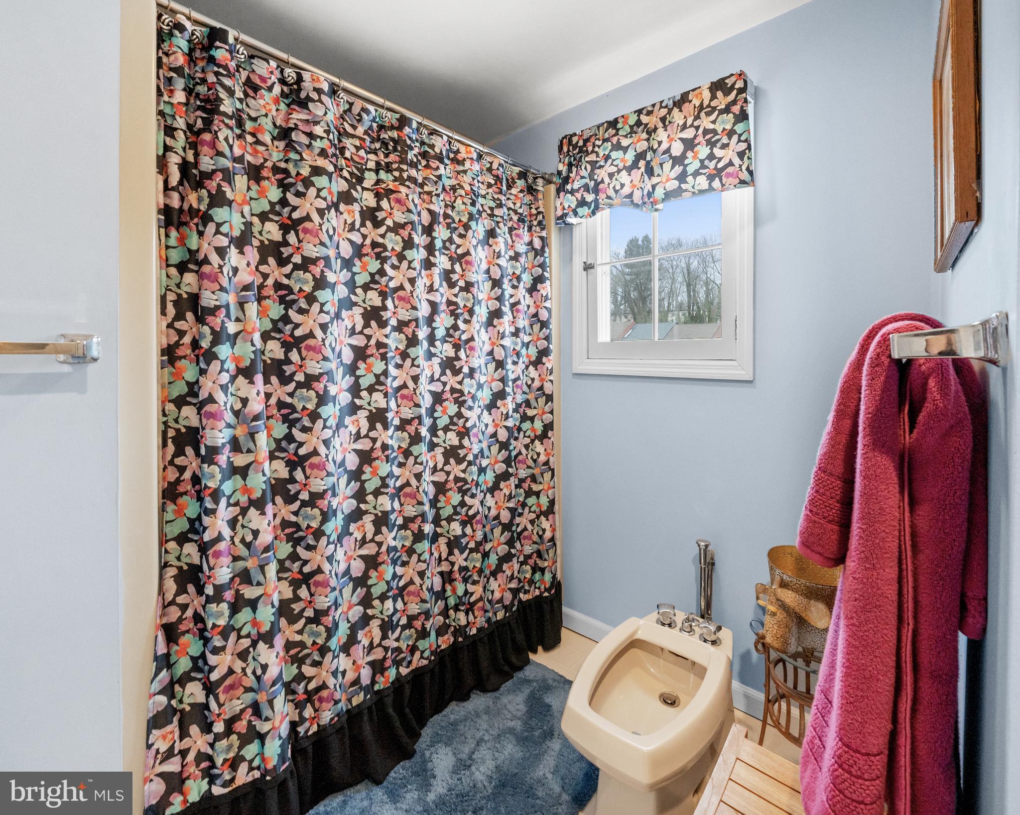 55 Ivy Road Wilmington, DE 19806 - Photo 24 of 38 a bathroom with a toilet and a shower curtain
