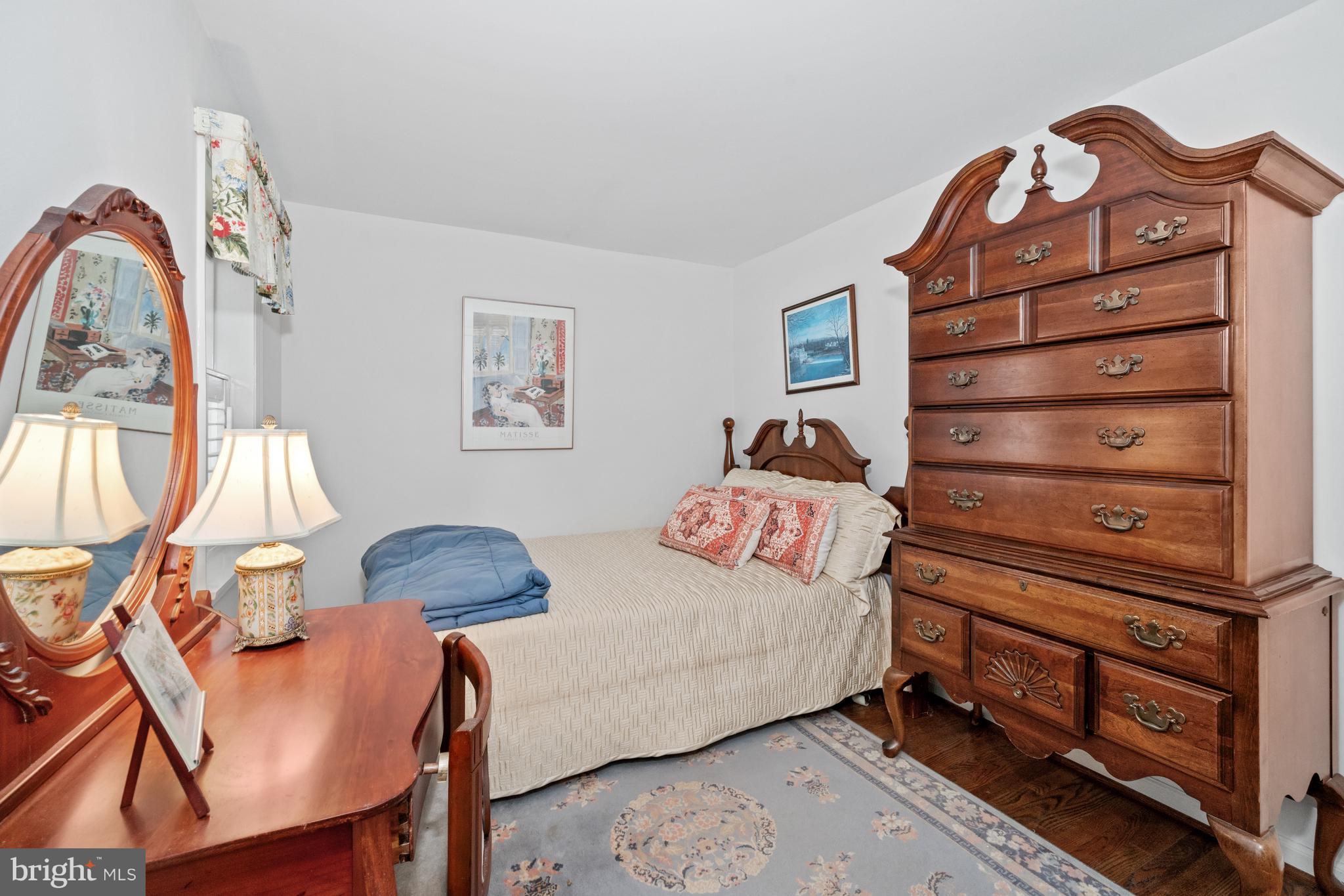 55 Ivy Road Wilmington, DE 19806 - Photo 25 of 38 a bedroom with a bed a dresser and wooden floor