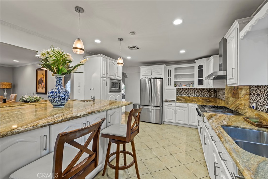 790 North El Molino Avenue Pasadena, CA 91104 - Photo 14 of 34 a kitchen with stainless steel appliances a sink a counter top space cabinets and wooden floor