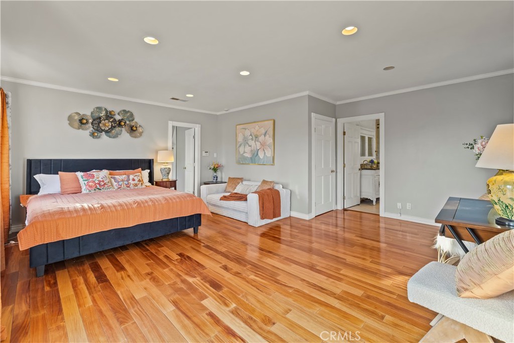 790 North El Molino Avenue Pasadena, CA 91104 - Photo 19 of 34 a bedroom with a large bed and a wooden floor