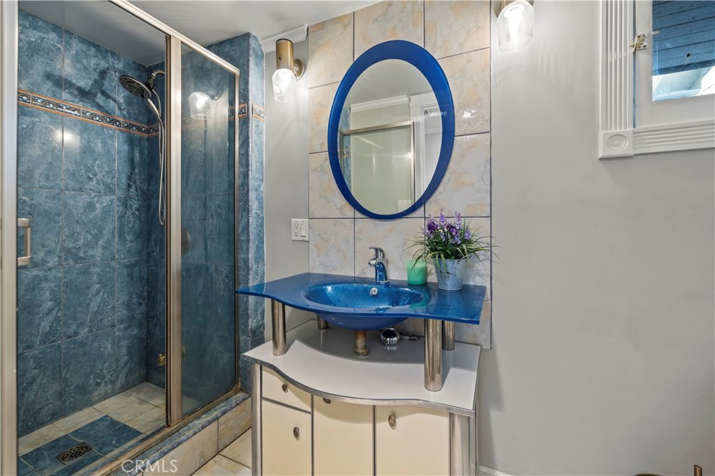790 North El Molino Avenue Pasadena, CA 91104 - Photo 29 of 34 a bathroom with a sink a mirror and a shower