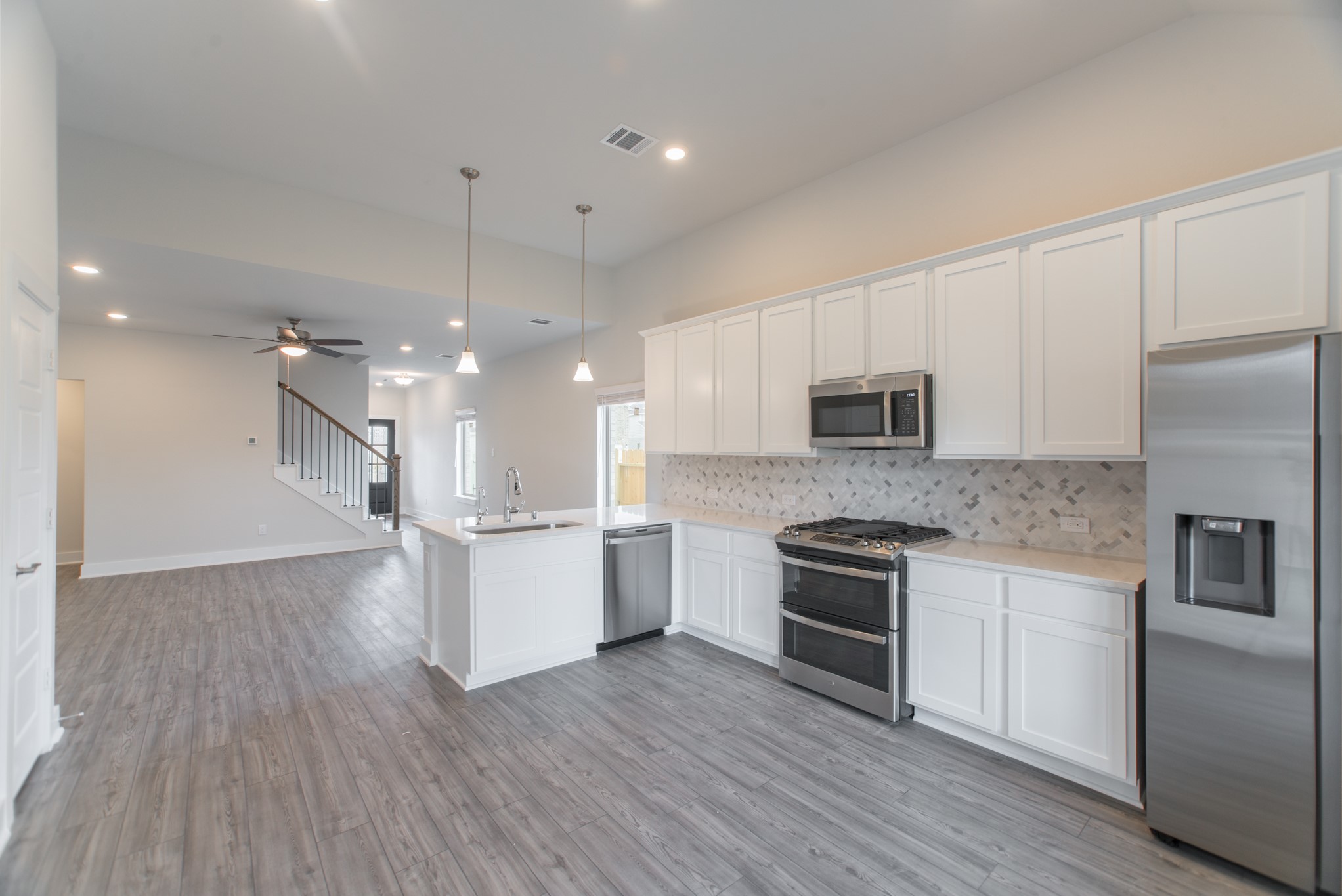 10539 Preserve Way Conroe, TX 77385 - Photo 11 of 31 a kitchen with a hard wood floor stainless steel appliances and wooden floor