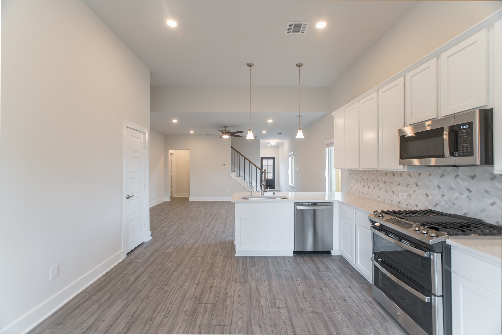10539 Preserve Way Conroe, TX 77385 - Photo 12 of 31 a kitchen with a stove and a microwave