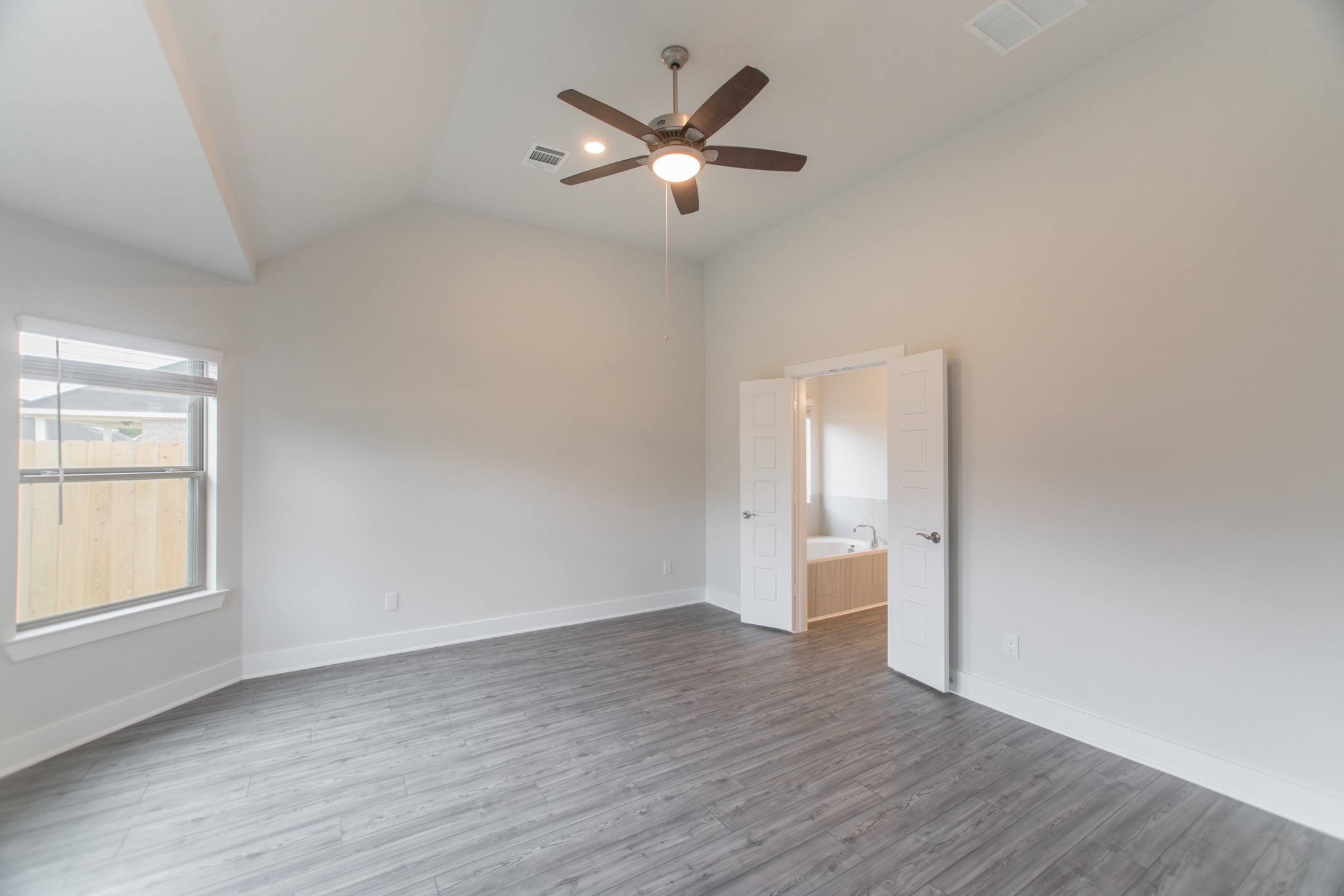 10539 Preserve Way Conroe, TX 77385 - Photo 13 of 31 an empty room with wooden floor and ceiling fan