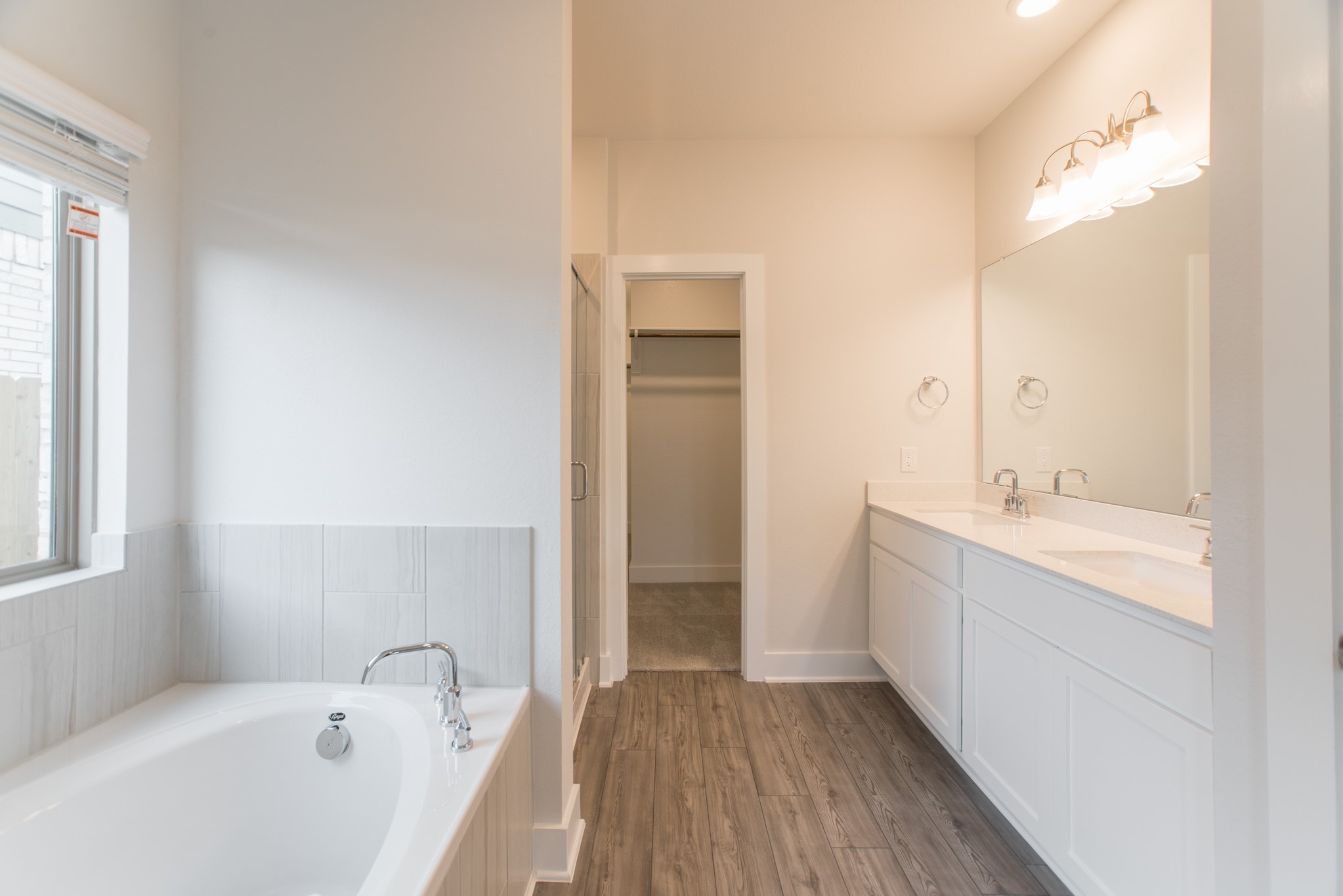 10539 Preserve Way Conroe, TX 77385 - Photo 15 of 31 a bathroom with a tub sink and mirror
