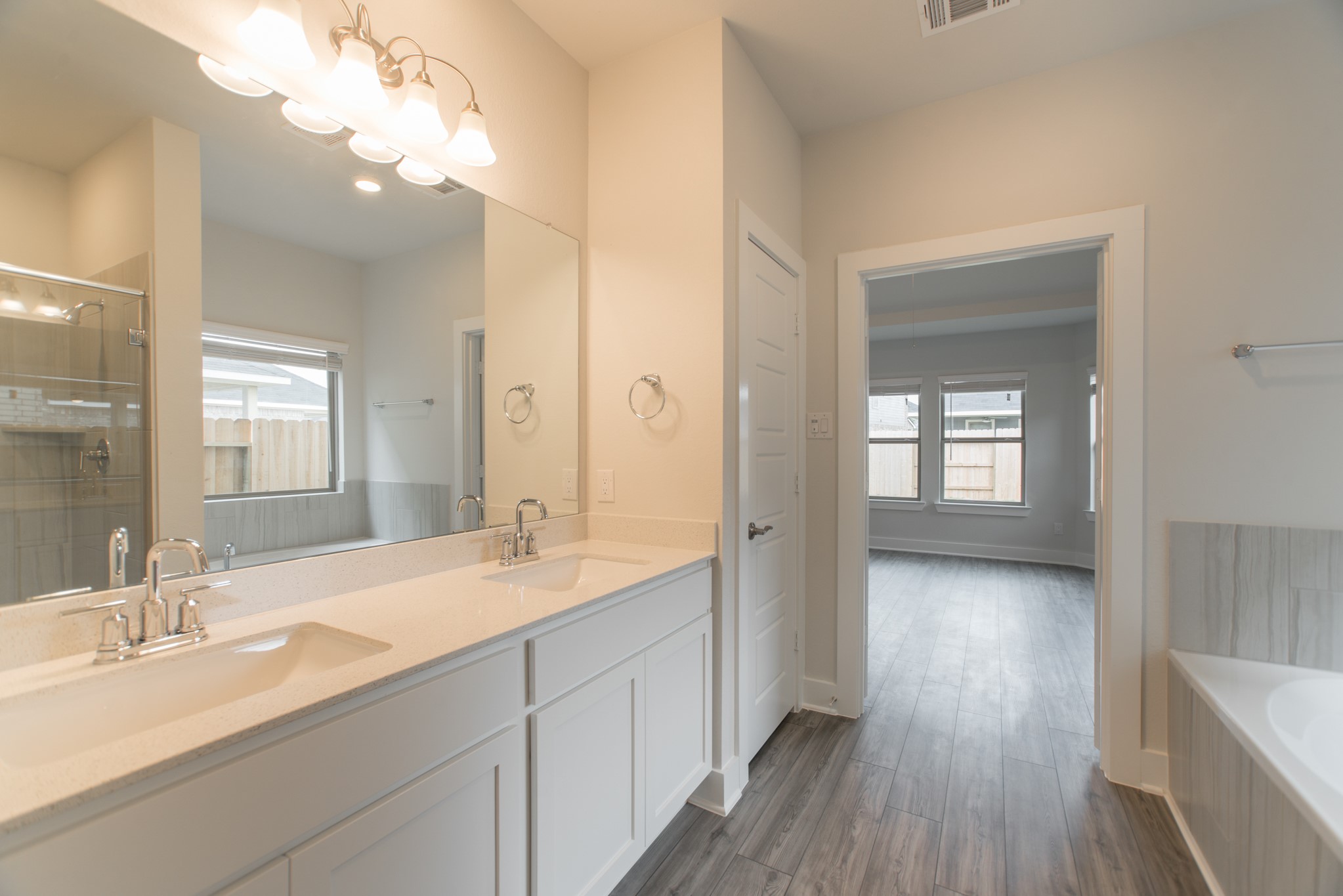 10539 Preserve Way Conroe, TX 77385 - Photo 19 of 31 a spacious bathroom with a granite countertop sink mirror and double