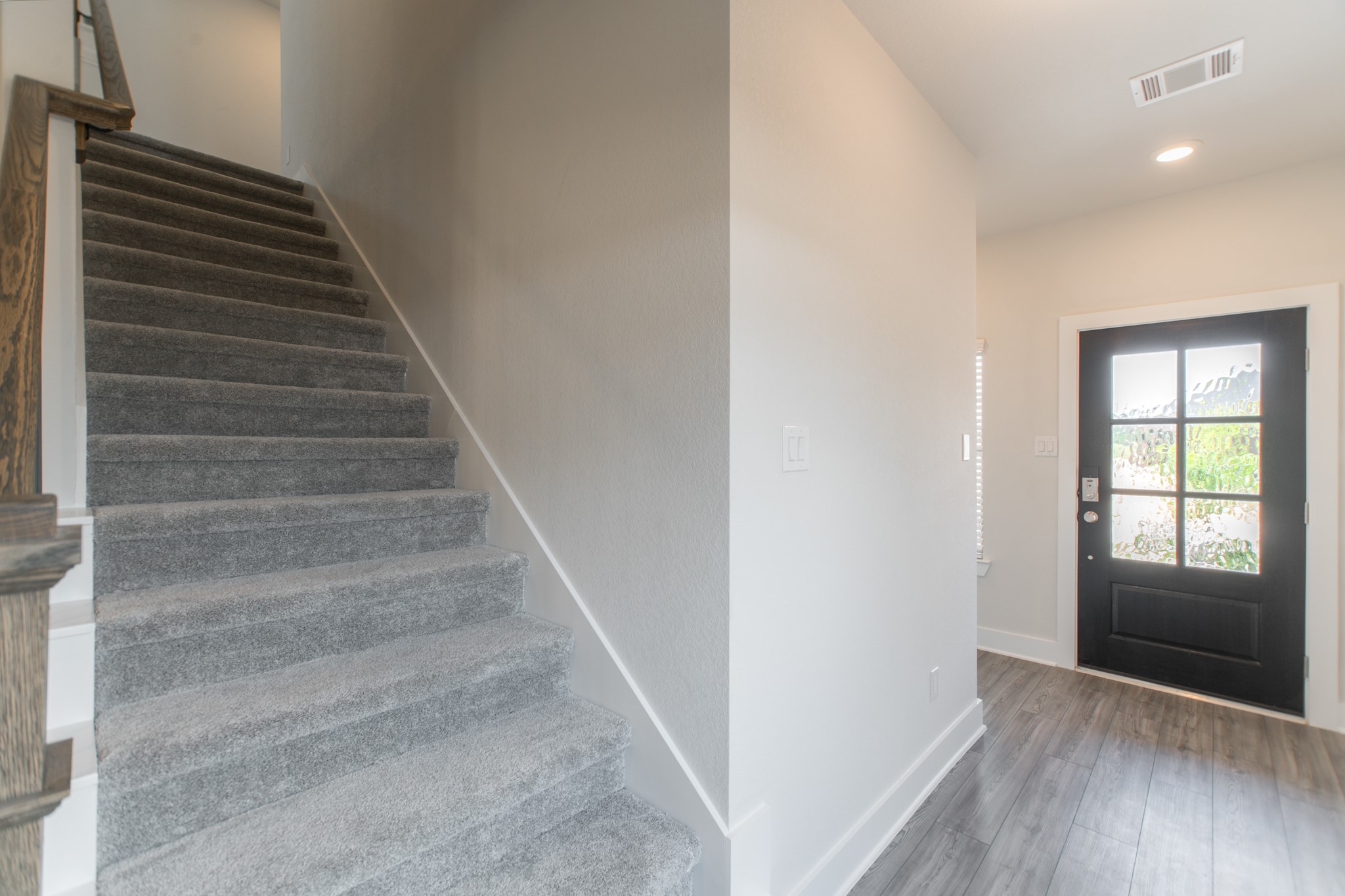 10539 Preserve Way Conroe, TX 77385 - Photo 20 of 31 a view of entryway with wooden floor and stairs