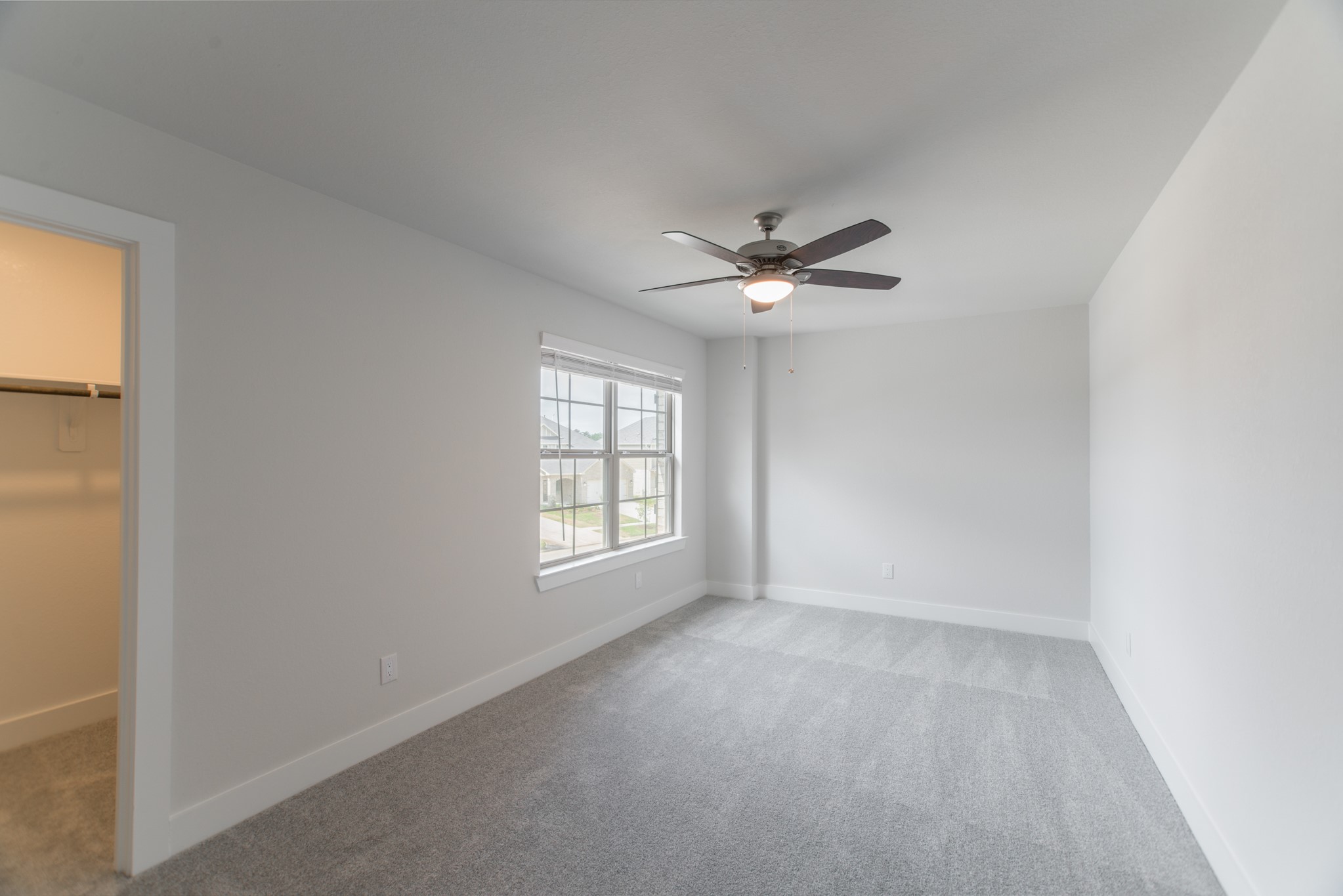 10539 Preserve Way Conroe, TX 77385 - Photo 23 of 31 an empty room with windows and fan