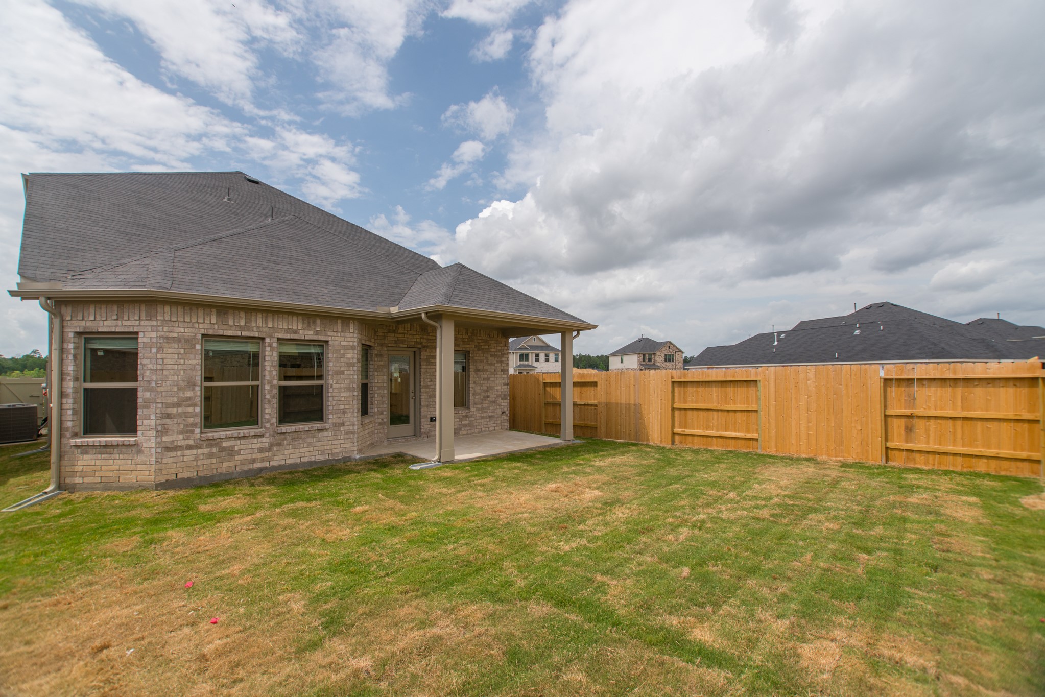 10539 Preserve Way Conroe, TX 77385 - Photo 30 of 31 a view of a house with a swimming pool with a yard