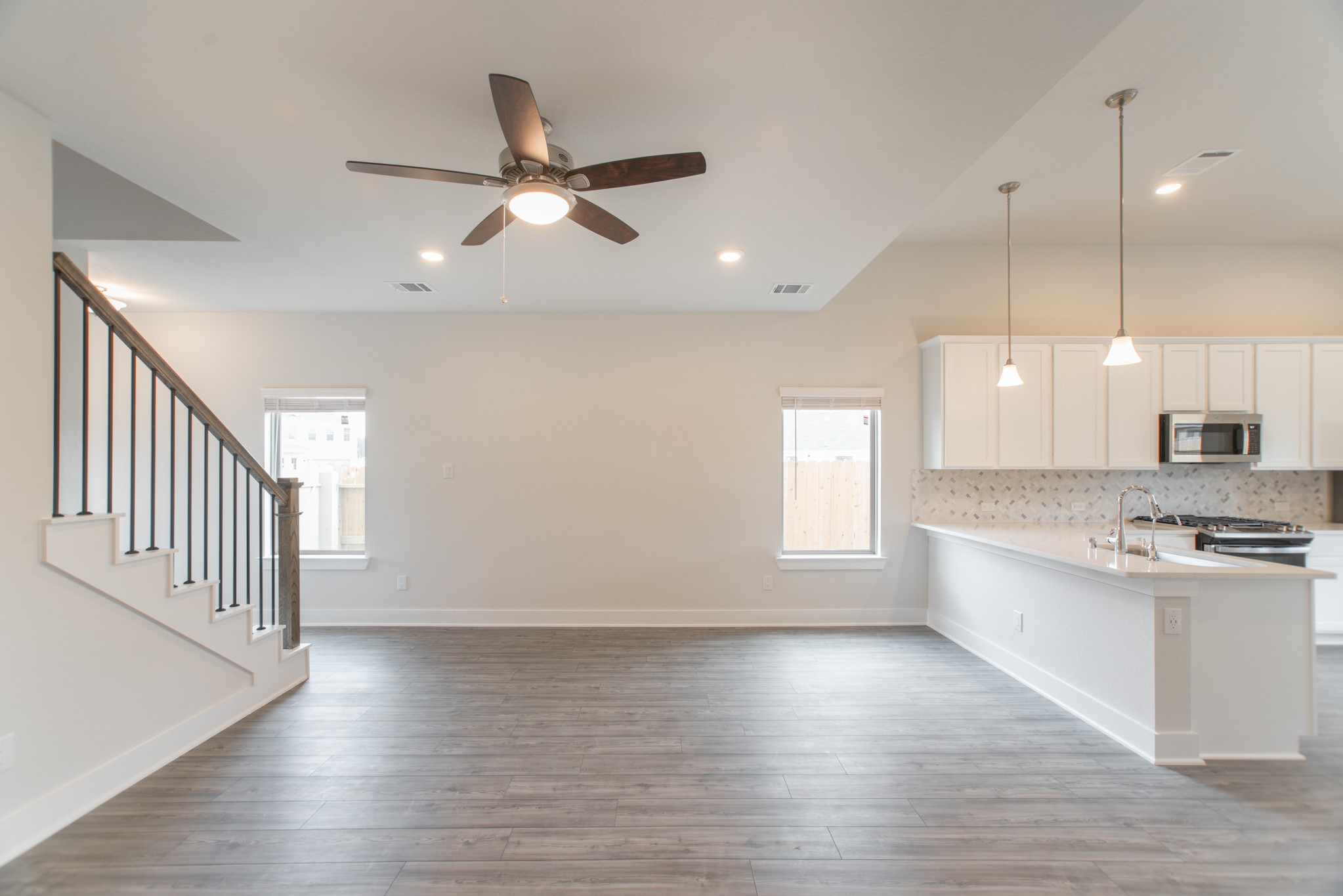 10539 Preserve Way Conroe, TX 77385 - Photo 6 of 31 a large kitchen with cabinets wooden floor and stainless steel appliances