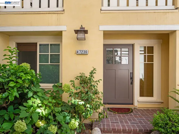 a front view of a house with a yard and seating space