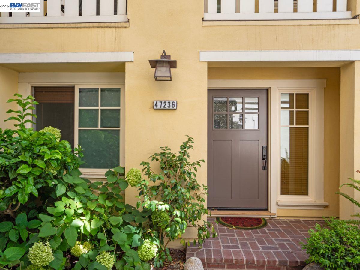 a front view of a house with a yard and seating space