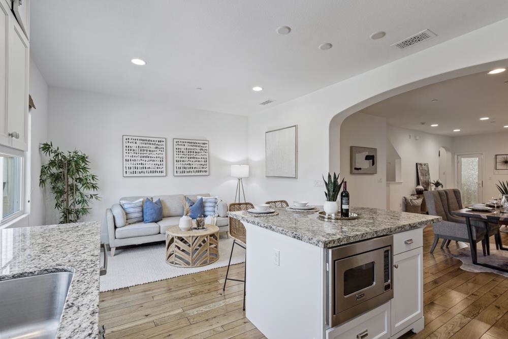 47236 Cavanaugh Common Fremont, CA 94539 - Photo 13 of 52 a kitchen with a stove a sink and a refrigerator