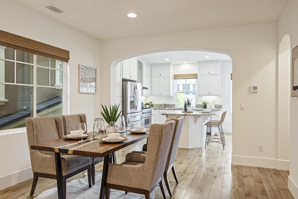 47236 Cavanaugh Common Fremont, CA 94539 - Photo 17 of 52 a view of a dining room with furniture and wooden floor