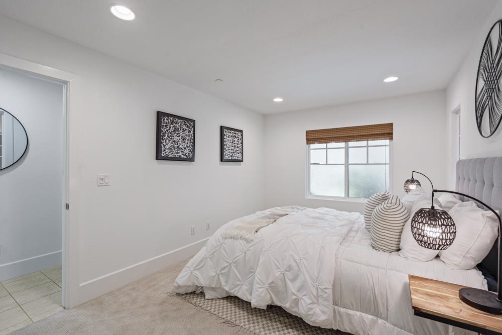 47236 Cavanaugh Common Fremont, CA 94539 - Photo 19 of 52 a bedroom with a bed and a chandelier