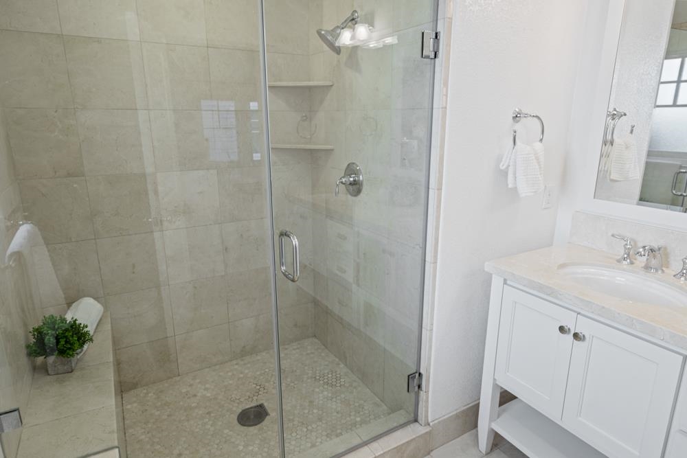 47236 Cavanaugh Common Fremont, CA 94539 - Photo 33 of 52 a bathroom with a shower sink and mirror