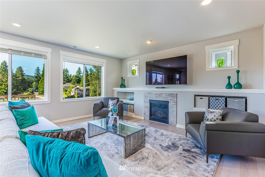 5638 Northeast 9th Street Renton, WA 98059 - Photo 12 of 40 a living room with furniture a large window and a fireplace