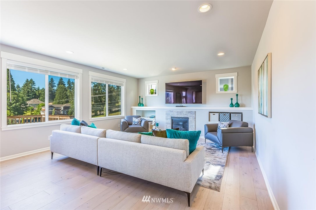 5638 Northeast 9th Street Renton, WA 98059 - Photo 14 of 40 a living room with fireplace furniture and a large window
