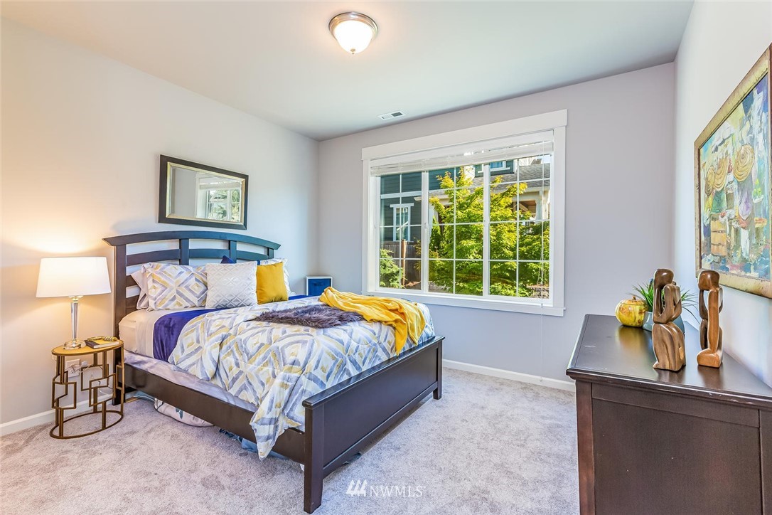 5638 Northeast 9th Street Renton, WA 98059 - Photo 15 of 40 a bed sitting in a bedroom next to a window