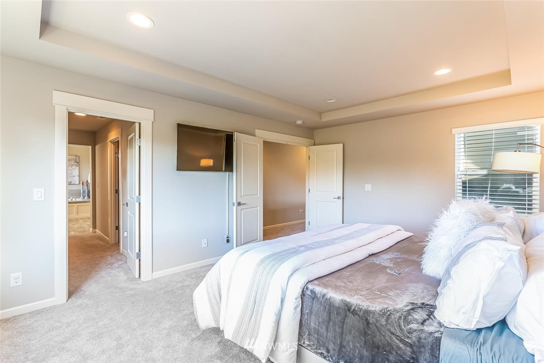 5638 Northeast 9th Street Renton, WA 98059 - Photo 18 of 40 a bedroom with a bed and a painting on the wall