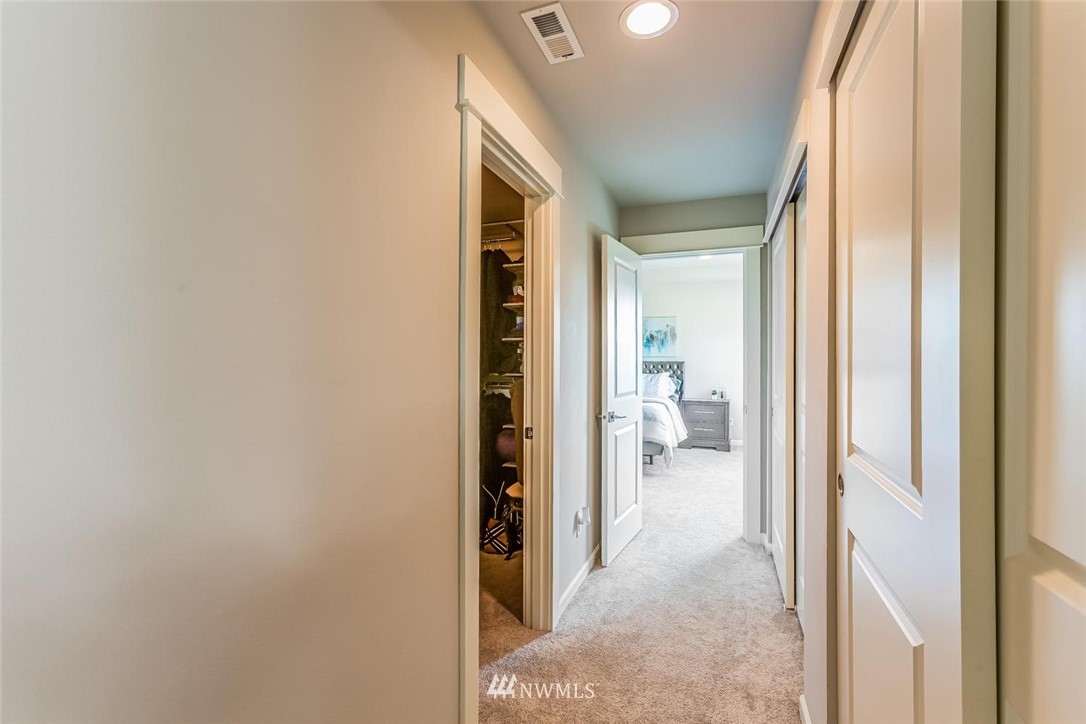 5638 Northeast 9th Street Renton, WA 98059 - Photo 19 of 40 a view of a hallway with white walls and stairs