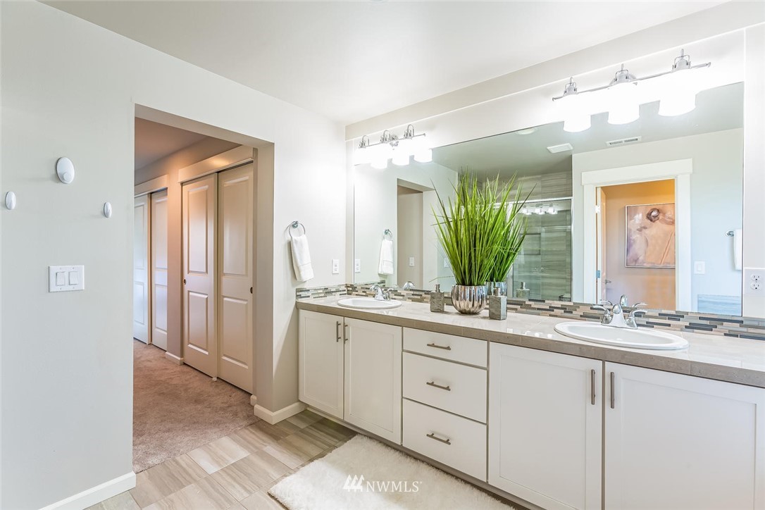5638 Northeast 9th Street Renton, WA 98059 - Photo 22 of 40 a bathroom with a double vanity sink and a mirror