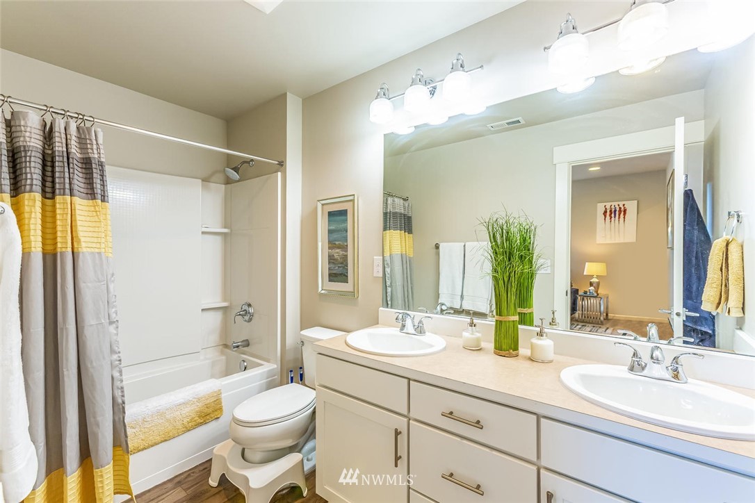 5638 Northeast 9th Street Renton, WA 98059 - Photo 26 of 40 a bathroom with a sink a toilet and shower