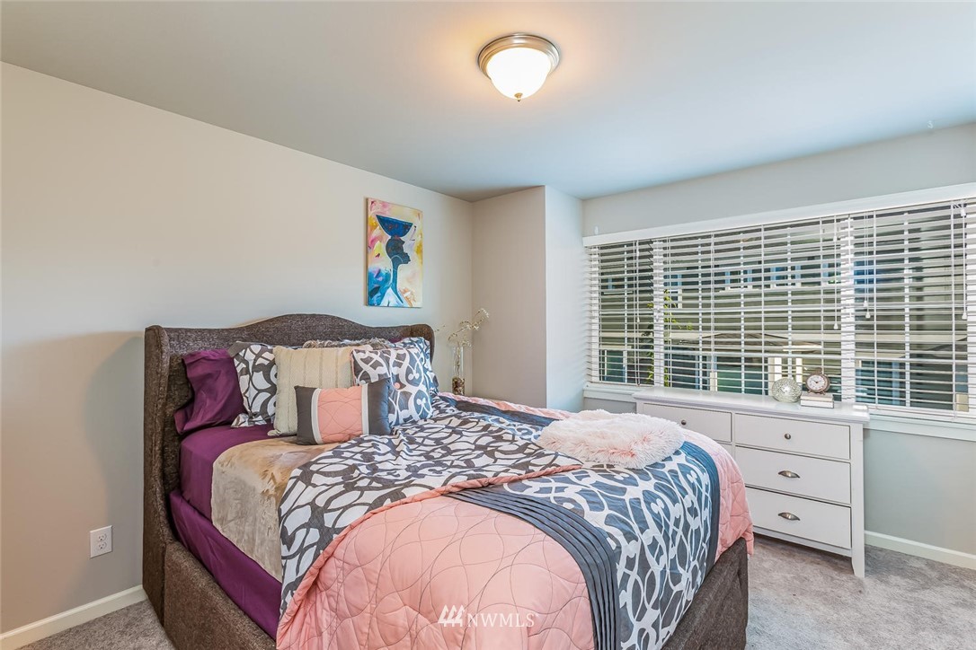 5638 Northeast 9th Street Renton, WA 98059 - Photo 27 of 40 a bedroom with a large bed and a large window