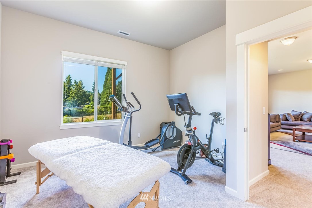 5638 Northeast 9th Street Renton, WA 98059 - Photo 34 of 40 a room filed with gym equipment with a view of living room