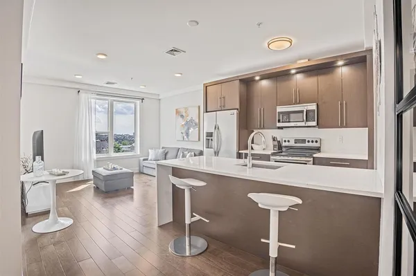 a kitchen with stainless steel appliances granite countertop a stove and a refrigerator