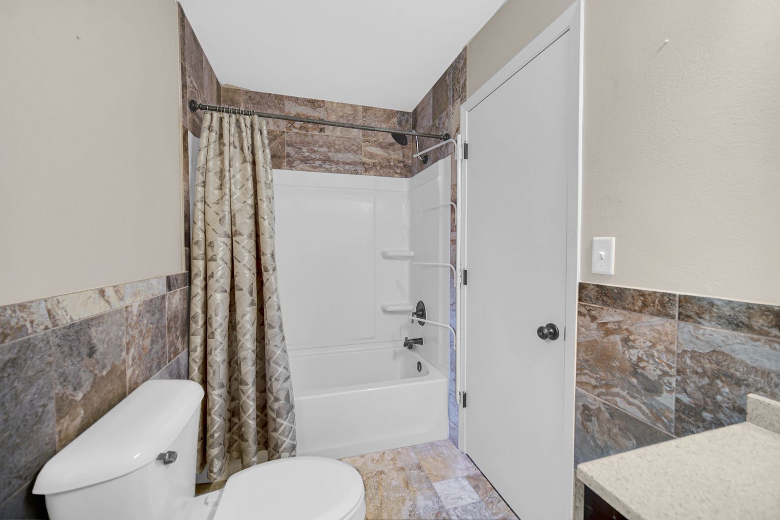 7427 McCurry Road Roscoe, IL 61073 - Photo 17 of 23 a bathroom with a shower curtain and a toilet