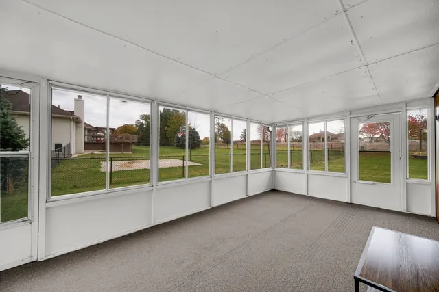 a view of an empty room with windows