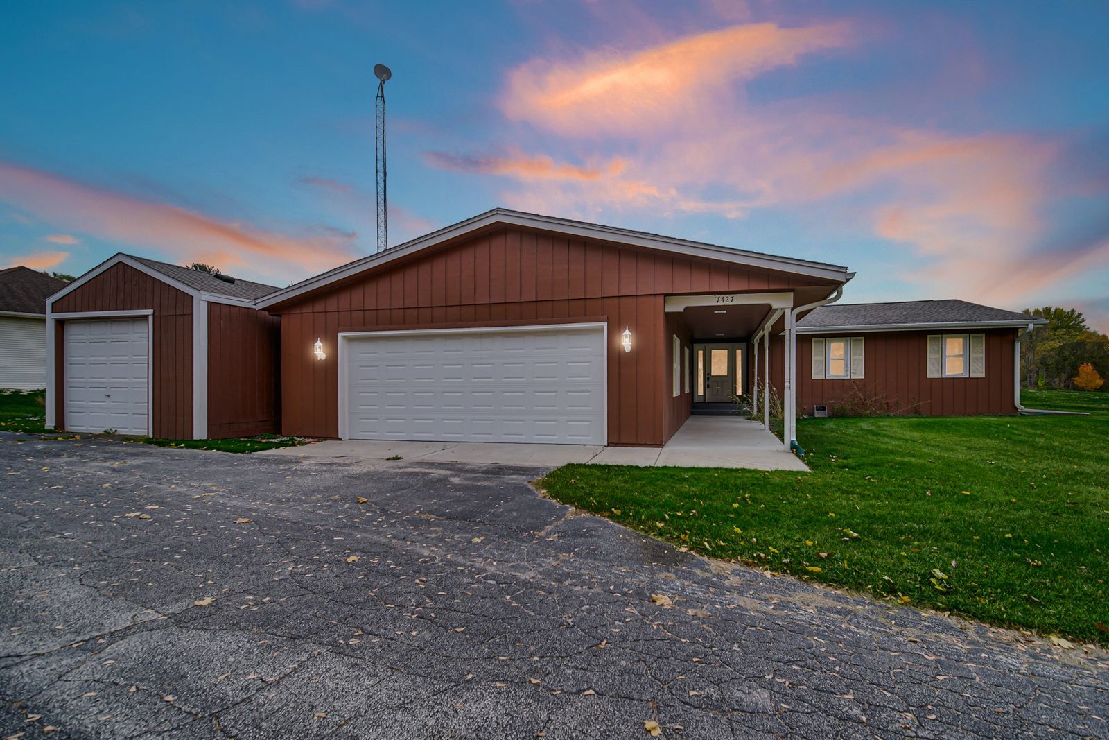 7427 McCurry Road Roscoe, IL 61073 - Photo 2 of 23 a front view of a house with a yard and garage