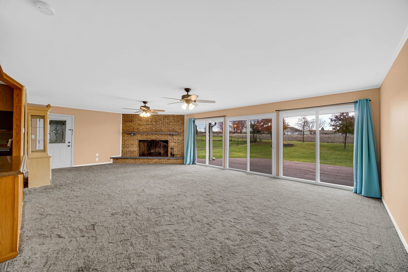7427 McCurry Road Roscoe, IL 61073 - Photo 4 of 23 a view of an empty room with a fireplace and a window