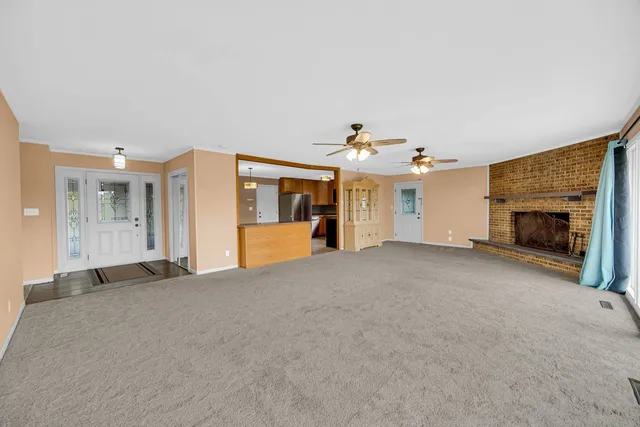 a view of a livingroom with a fireplace and a chandelier