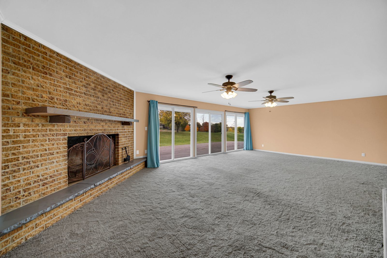 7427 McCurry Road Roscoe, IL 61073 - Photo 6 of 23 a view of an empty room with a fireplace and a window