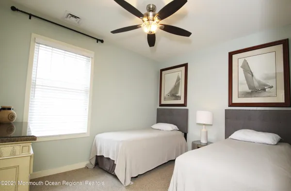 a bedroom with two beds and a window