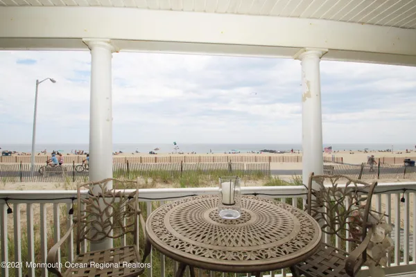 a view of a balcony with table and chairs
