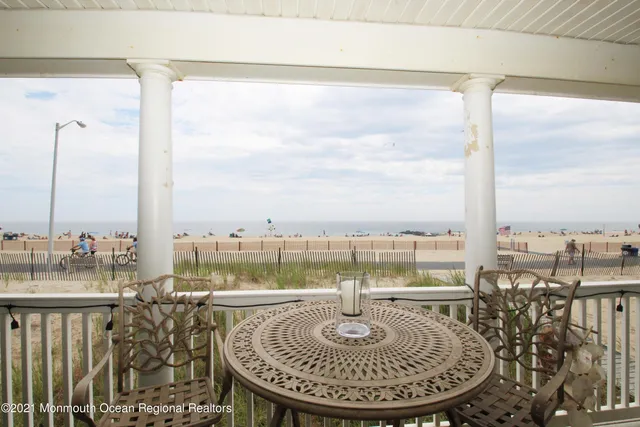 a view of a balcony with table and chairs