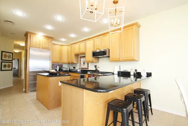a kitchen with a sink a counter top space cabinets and stainless steel appliances