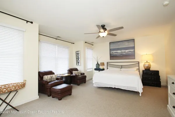 a bedroom with bed couch and window