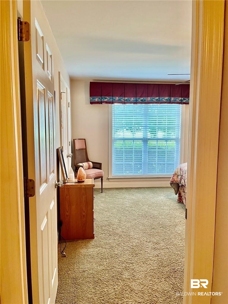 16311 Old Brady Road Bay Minette, AL 36507 - Photo 27 of 38 Carpeted interior room featuring a large window with horizontal blinds, a decorative valance, and neutral wall paint