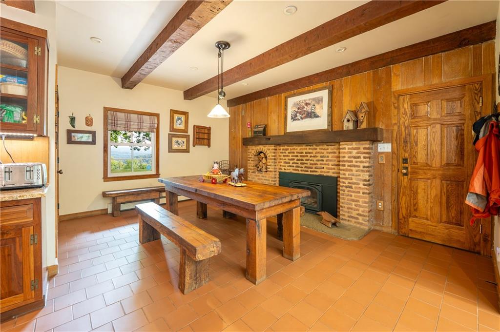 127 Mountain Road Ligonier, PA 15658 - Photo 14 of 45 a living room with a fireplace furniture a ceiling fan and a window