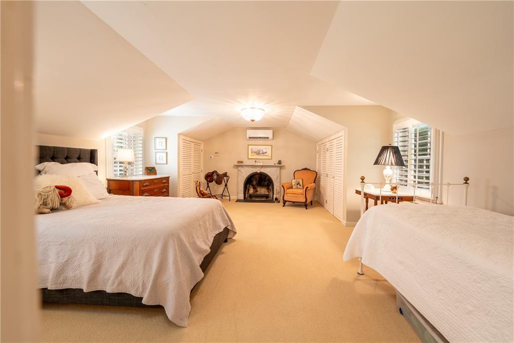 127 Mountain Road Ligonier, PA 15658 - Photo 21 of 45 a spacious bedroom with a bed and a lamp