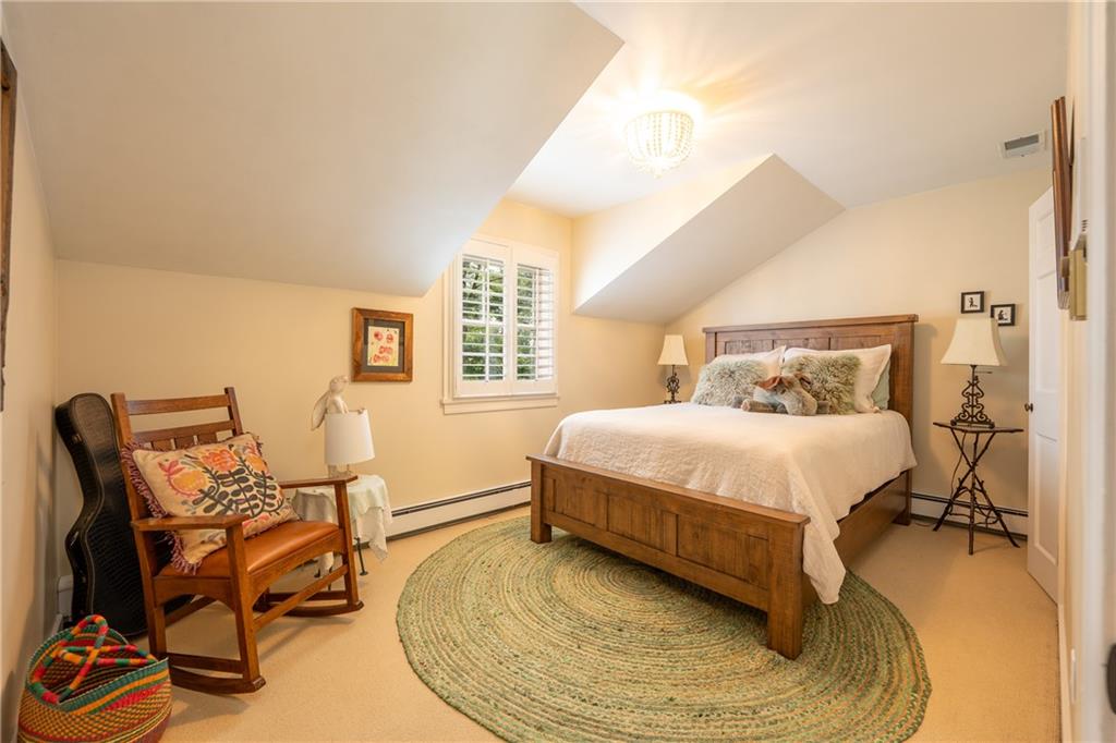 127 Mountain Road Ligonier, PA 15658 - Photo 25 of 45 a bedroom with a bed a chair and the dresser next to a window