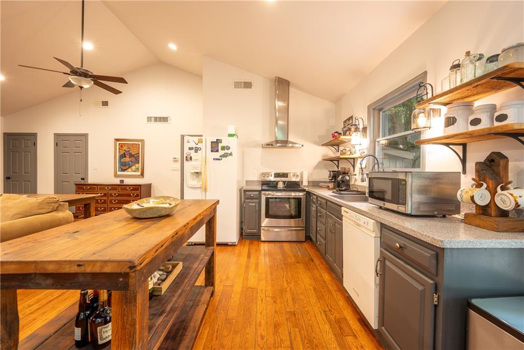 127 Mountain Road Ligonier, PA 15658 - Photo 34 of 45 a kitchen with stainless steel appliances granite countertop a sink a stove and a refrigerator